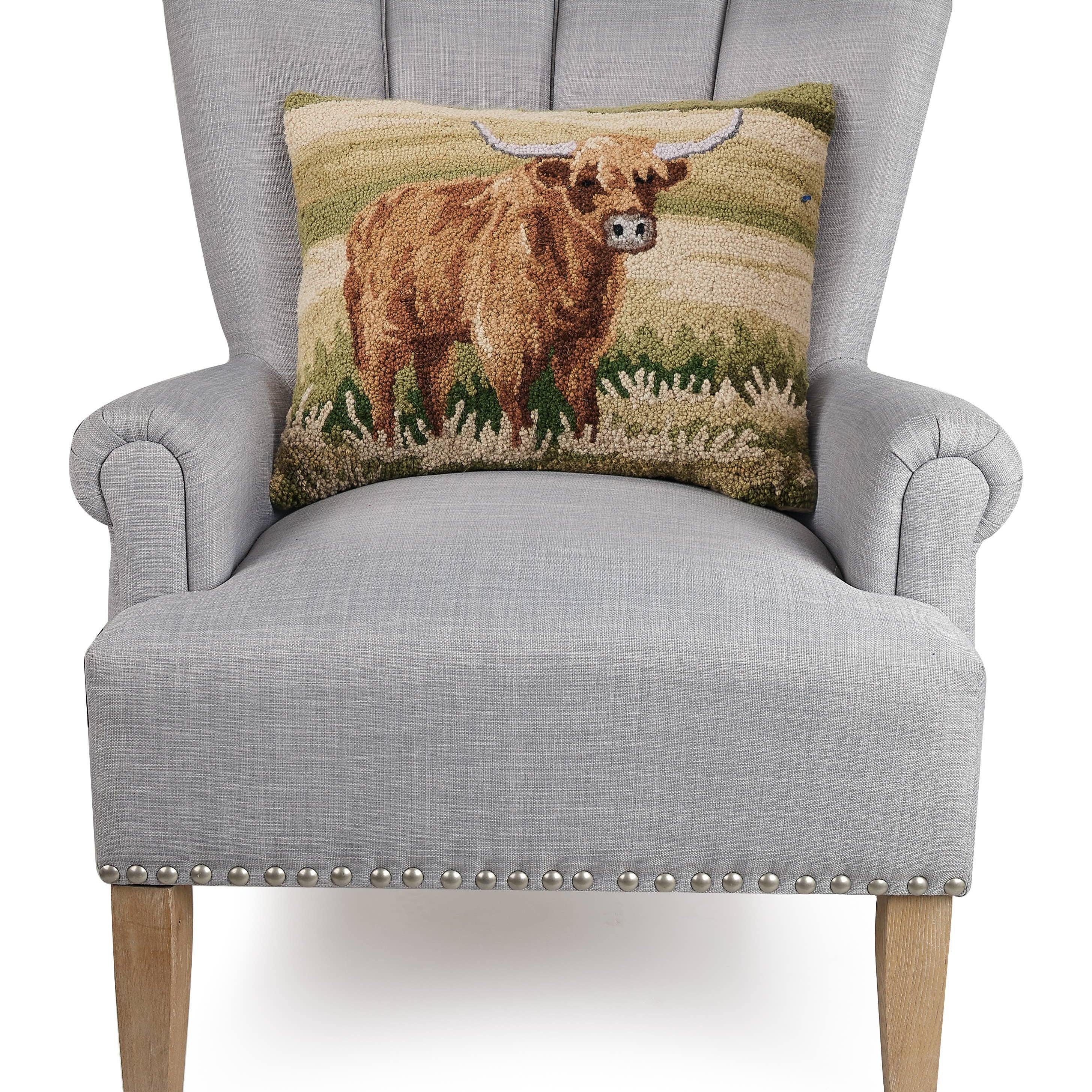 Highland Cow Pillow needlepoint on a chair
